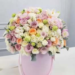 Pastel rose bouquet in a pink hatbox with ribbon handles