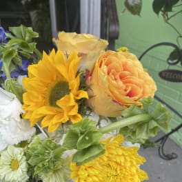 Bouquet with yellow sunflower, peach rose, and white daisies