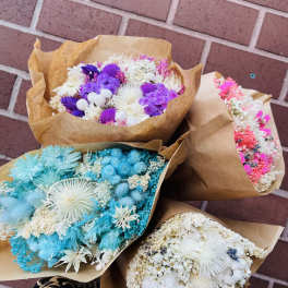 Bouquets of dried flowers wrapped in brown paper