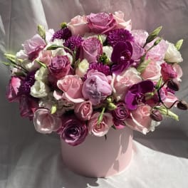 Pink and purple mixed bouquet in a pale pink hat box