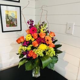 Bright mixed flower arrangement in a clear glass vase