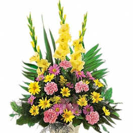 Tall floral arrangement with yellow and pink flowers in a decorative container