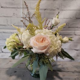 Blush rose and white hydrangea arrangement in a glass vase