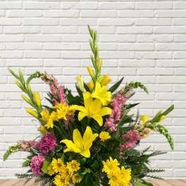 Yellow lilies and pink flowers in a mixed bouquet