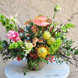 Colorful mixed floral arrangement in a round vase