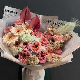 Pink and cream bouquet with gerbera daisies and anthuriums in paper wrap