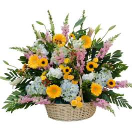 Basket arrangement of yellow, pink, and white flowers