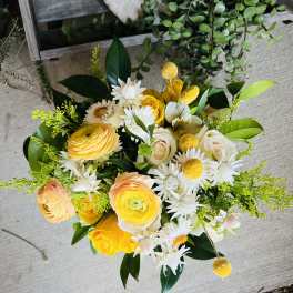 Bouquet of yellow and white flowers with green foliage