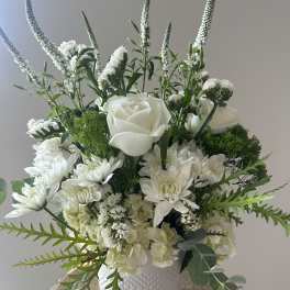 White floral arrangement in a textured white vase
