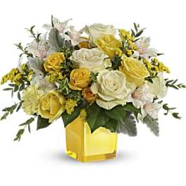 Yellow and white rose bouquet in a square glass vase