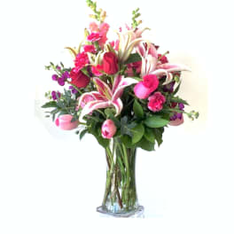 Pink and white floral bouquet in a clear glass vase