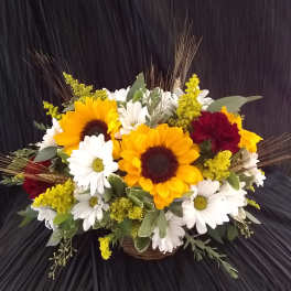 Sunflower and daisy bouquet in a wicker basket