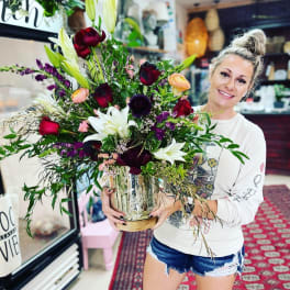 Large mixed bouquet in a glass vase with lilies and roses