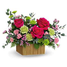Pink roses and carnations in a wooden box