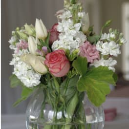 Bouquet of pink and white flowers in a clear glass vase