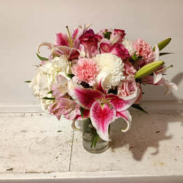 Pink and white mixed bouquet in a clear glass vase