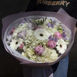Bouquet of white and pink flowers wrapped in pale pink paper