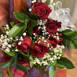 Bouquet of red roses with white baby's breath and greenery