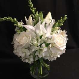 White floral bouquet in a clear glass vase