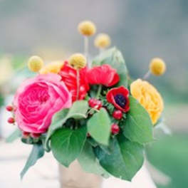 Small bouquet of pink, red, and yellow flowers in a vase