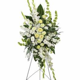 Tall white and green standing funeral spray on a metal easel