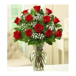 Red roses arranged in a clear glass vase