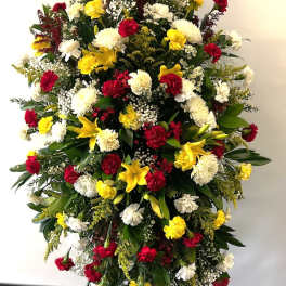 Large standing floral spray with red, white, and yellow flowers