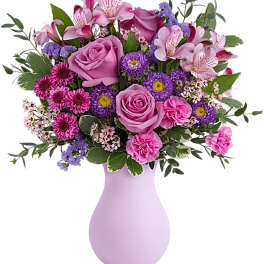 Pink and purple mixed bouquet in a lavender vase