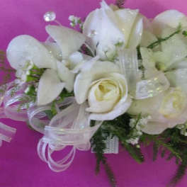 White rose and orchid bouquet with sheer ribbon on pink background