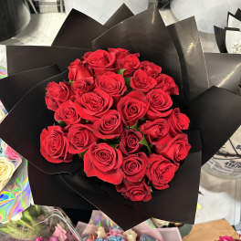 Bouquet of red roses wrapped in black paper