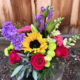 Colorful bouquet with sunflowers, roses, and purple blooms