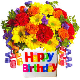 Birthday flower arrangement in a white container with colorful ribbon curls