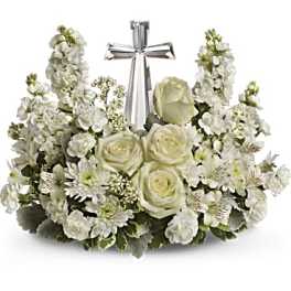 White floral arrangement with a silver cross centerpiece