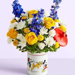 Bouquet of yellow, white, and blue flowers in a Mickey Mouse tin
