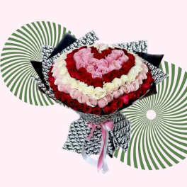 Heart-shaped bouquet of red, pink, and white roses with patterned wrapping