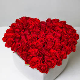 Heart-shaped box filled with red roses