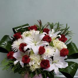 Red roses and white lilies in a pink box arrangement