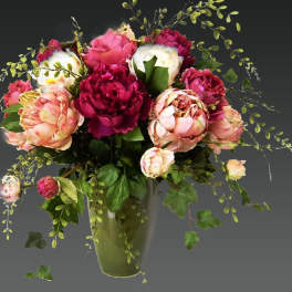 Bouquet of pink and white peonies in a glass vase