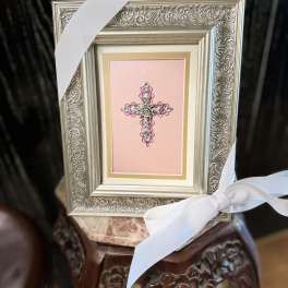 Framed pink cross ornament with white ribbon bow
