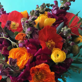 Bright mixed bouquet with red, orange, yellow, and purple flowers