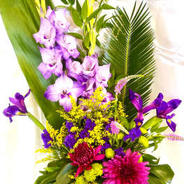Tropical bouquet with purple orchids, pink chrysanthemums, and yellow filler flowers