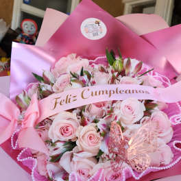 Pink rose bouquet with a birthday ribbon and butterfly decoration