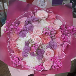 Bouquet of pink and purple flowers wrapped in magenta paper