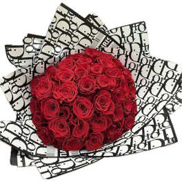 Bouquet of red roses wrapped in black-and-white patterned paper