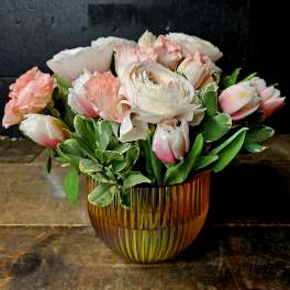 Pink and white bouquet in an amber glass vase