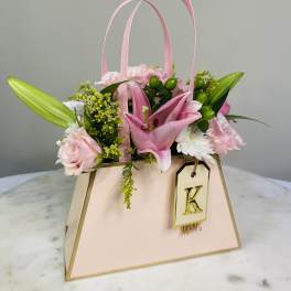 Pink floral gift bag with lilies and roses