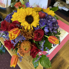 Mixed bouquet with sunflowers, roses, hydrangeas, and tulips
