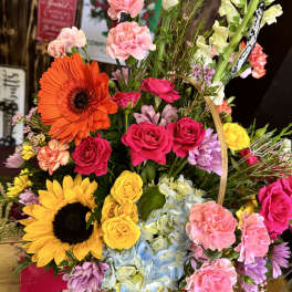Colorful mixed bouquet with sunflowers, roses, hydrangeas, and carnations