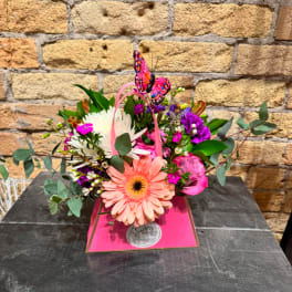 Pink and white mixed bouquet in a bright pink gift box with a butterfly topper