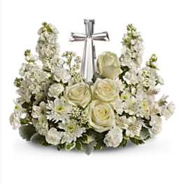 White floral arrangement with roses and a silver ribbon cross